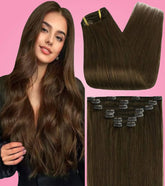 Dark brown clip-in hair extensions with long voluminous waves worn by model on pink background