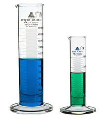 Graduated glass milk checker cylinders filled with blue and green liquid