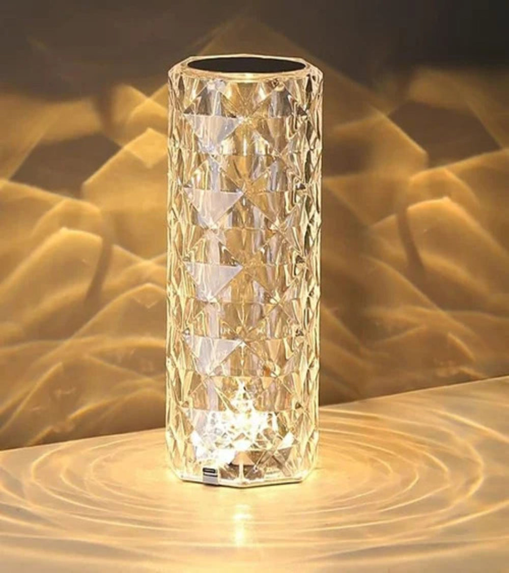 Crystal table lamp glowing with golden light
